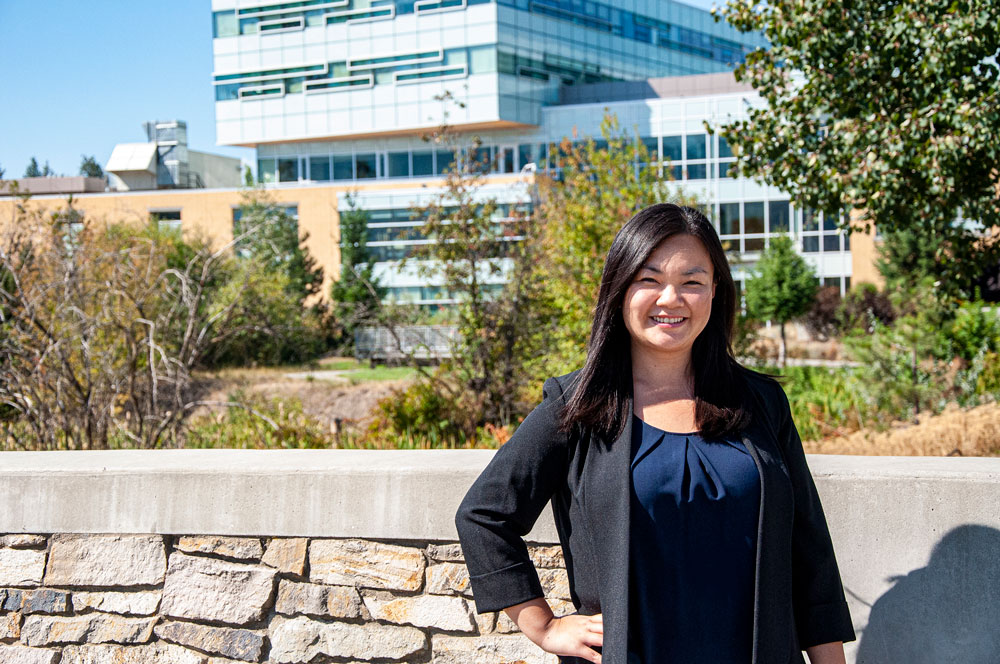 Dr. Jessica Chan standing in front of the Engineering, Management and Education Building at UBCO. 