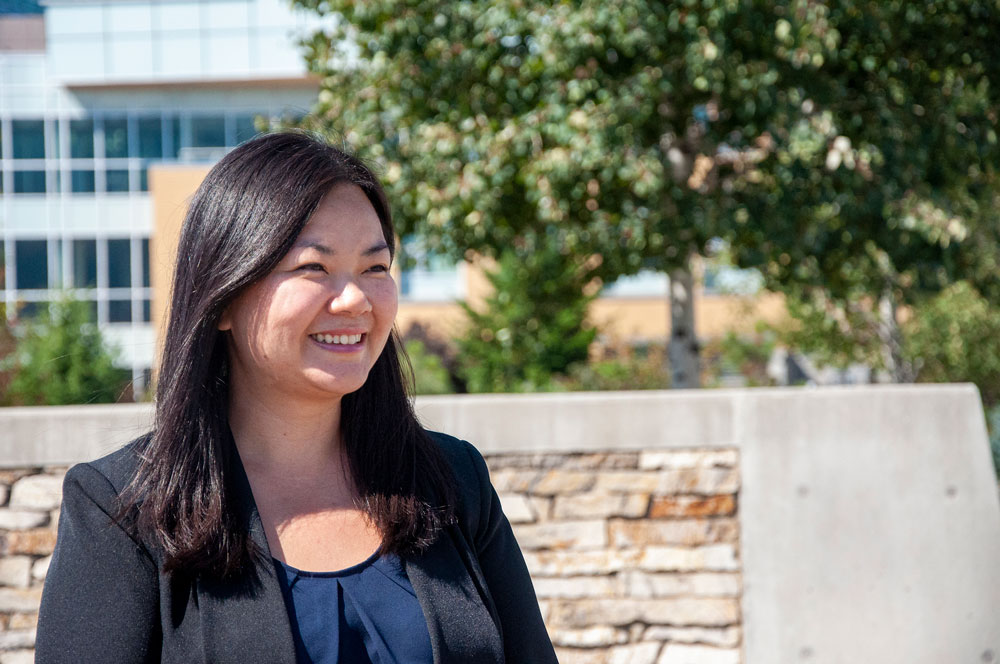 Close up of Dr. Jessica Chan looking out into the distance while standing in front of the EME building. 